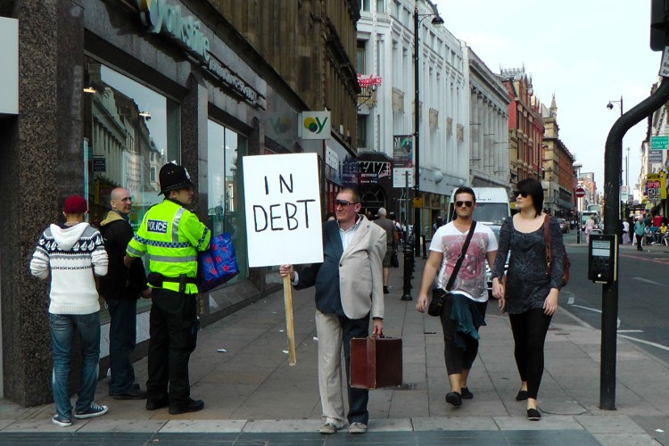 bob as trickster holding in debt sign